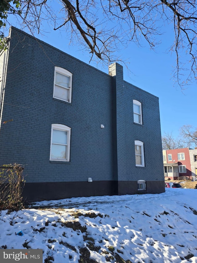 view of snow covered exterior featuring central air condition unit