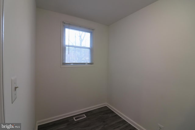 unfurnished room featuring dark wood-type flooring