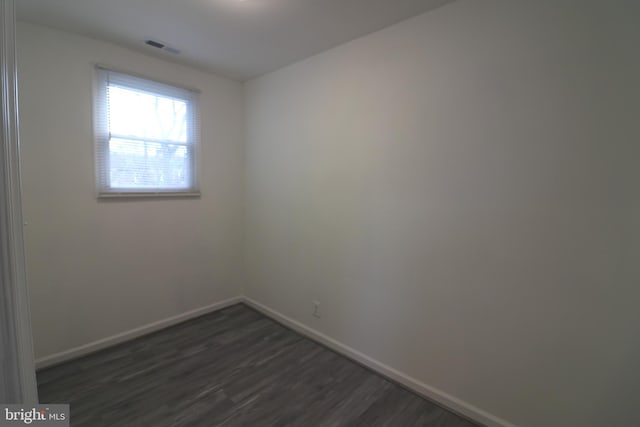 empty room featuring dark hardwood / wood-style flooring