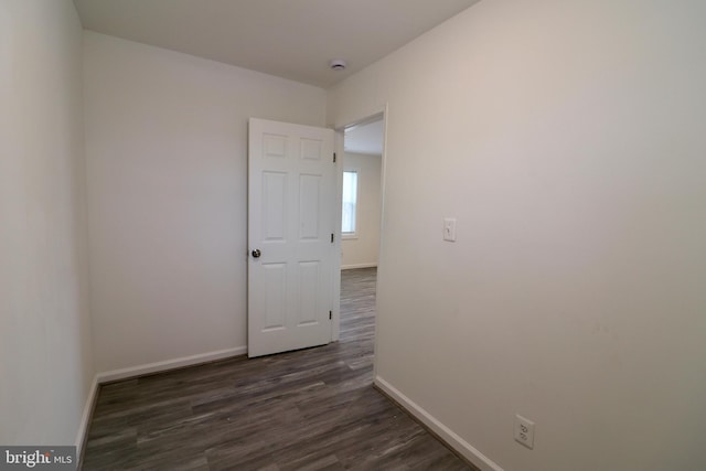 spare room with dark hardwood / wood-style flooring