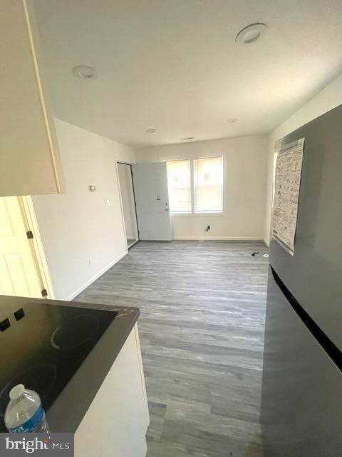 unfurnished living room with wood-type flooring