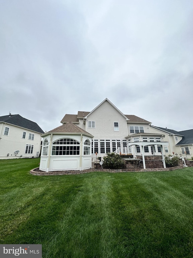 rear view of house with a yard