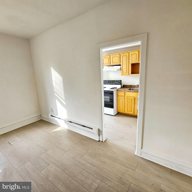 interior space with a baseboard radiator, light hardwood / wood-style floors, and sink