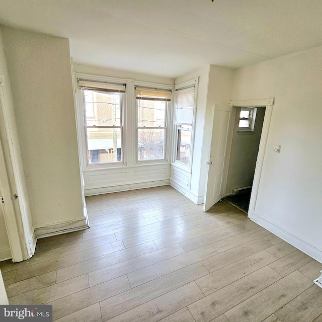 empty room with light hardwood / wood-style floors