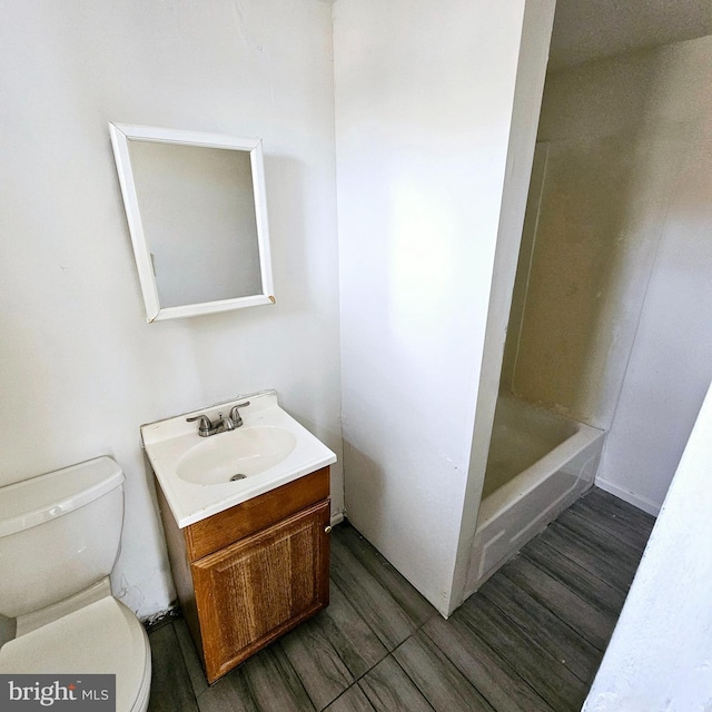 full bathroom with hardwood / wood-style flooring, vanity, independent shower and bath, and toilet