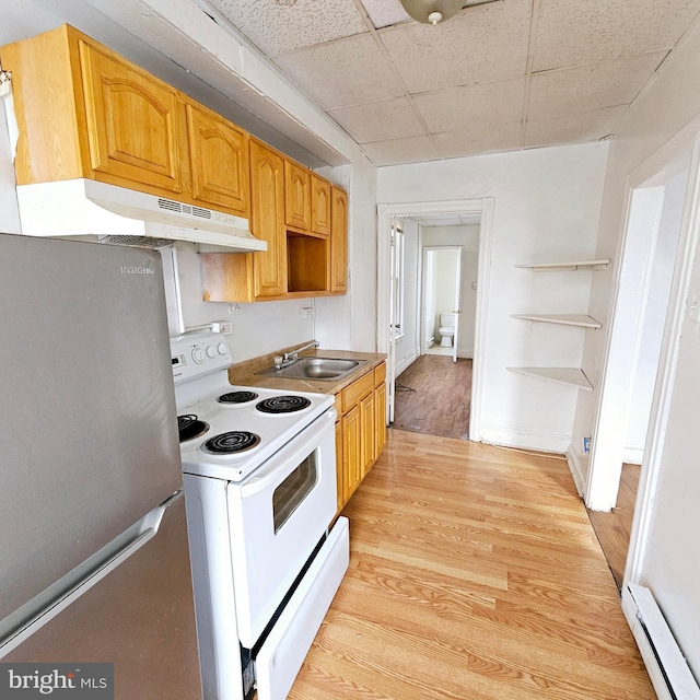 kitchen featuring a drop ceiling, sink, electric range, stainless steel fridge, and baseboard heating