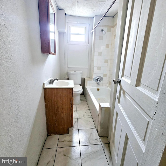 full bathroom featuring vanity, toilet, and tiled shower / bath