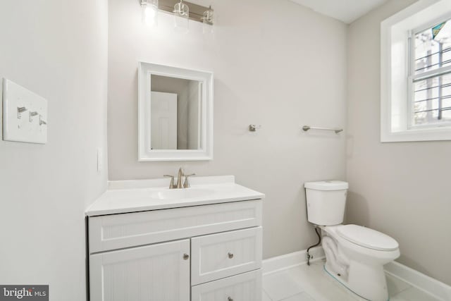 bathroom with tile patterned floors, vanity, and toilet