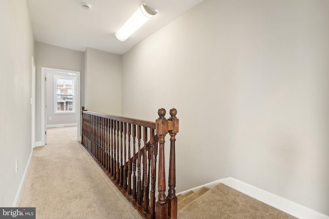 hallway with light carpet and lofted ceiling