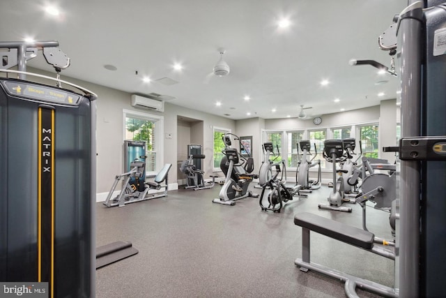 workout area featuring plenty of natural light and an AC wall unit