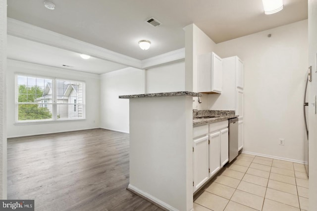 kitchen featuring stone counters, crown molding, kitchen peninsula, and white cabinets