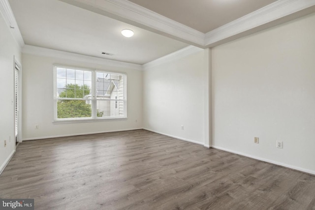 empty room featuring hardwood / wood-style floors and ornamental molding