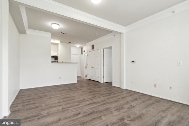 unfurnished living room featuring crown molding and hardwood / wood-style flooring