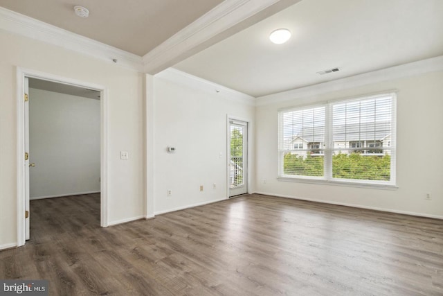 spare room featuring dark wood-type flooring and ornamental molding