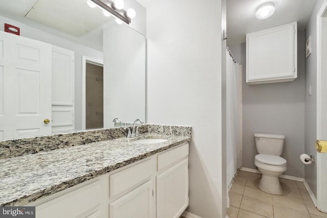 bathroom with vanity, toilet, and tile patterned flooring