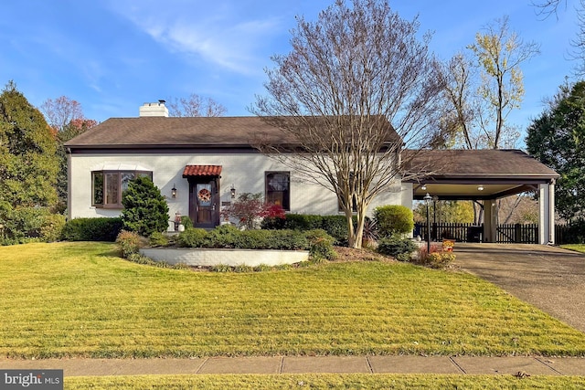 view of front facade with a carport and a front lawn