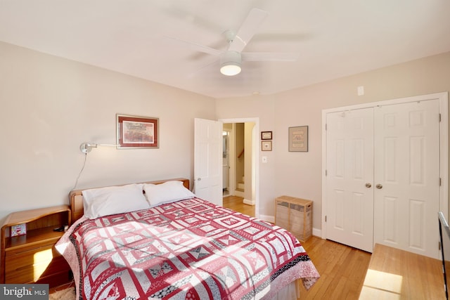 bedroom featuring light wood-type flooring, ceiling fan, and a closet