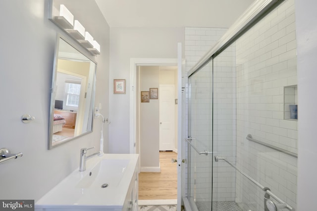 bathroom featuring an enclosed shower and vanity