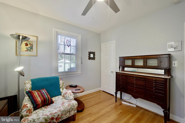 sitting room with ceiling fan and light hardwood / wood-style floors