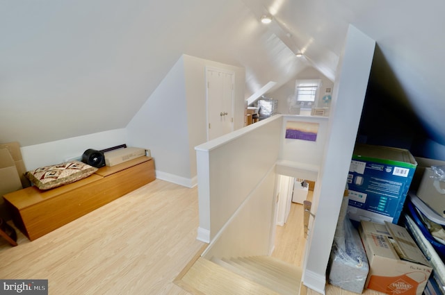 interior space featuring lofted ceiling and wood-type flooring