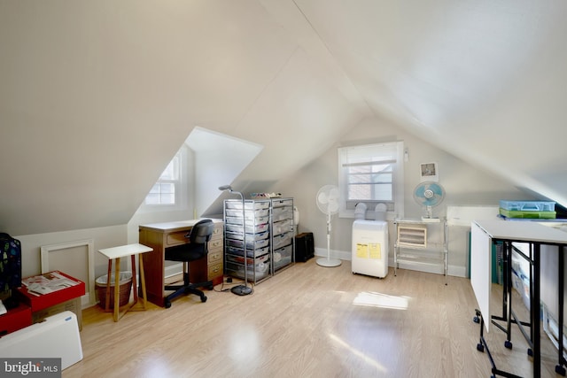 office area featuring lofted ceiling, light hardwood / wood-style floors, and plenty of natural light