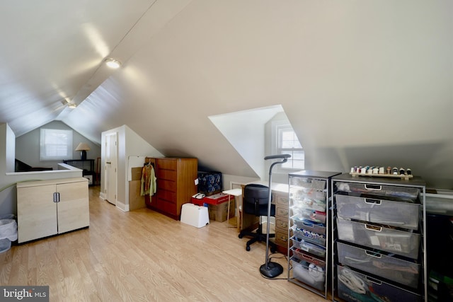 interior space with light wood-type flooring and lofted ceiling