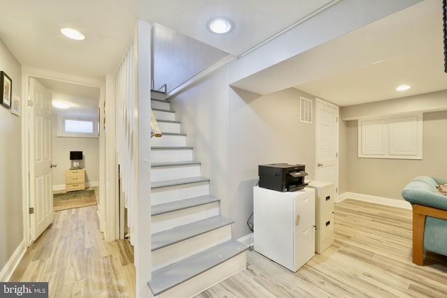 basement featuring light hardwood / wood-style floors