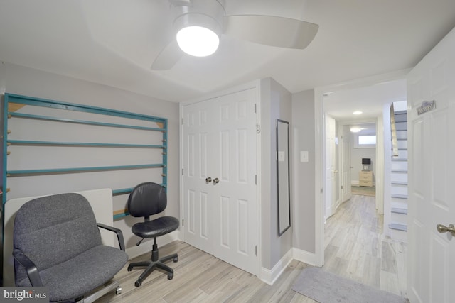 home office featuring ceiling fan and light hardwood / wood-style flooring