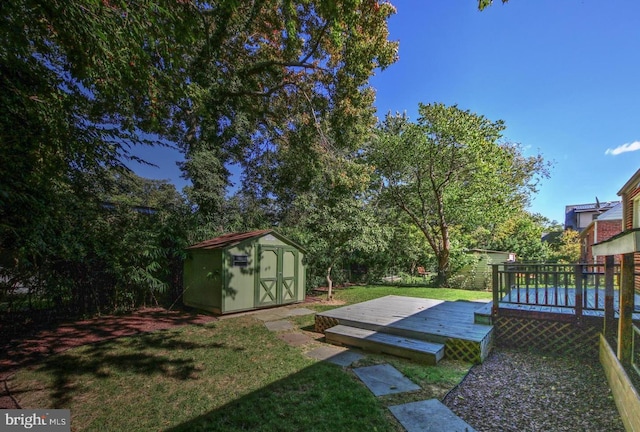 view of yard with a wooden deck and a storage shed