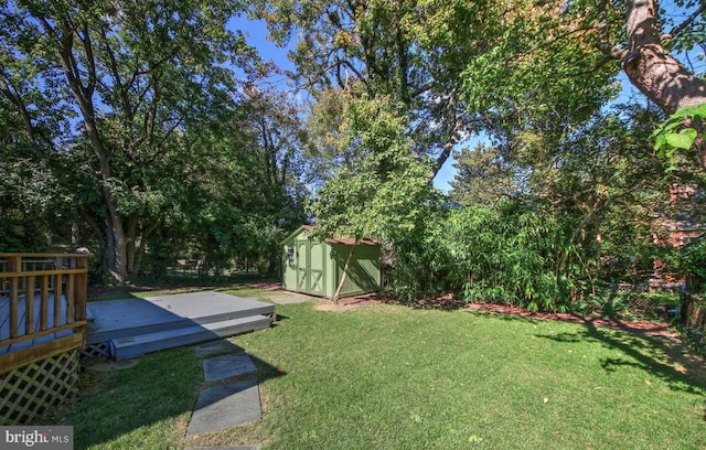 view of yard with a deck and a shed