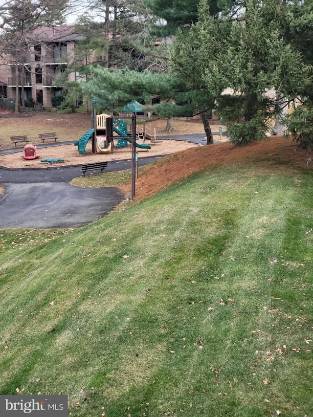 exterior space with a lawn and a playground