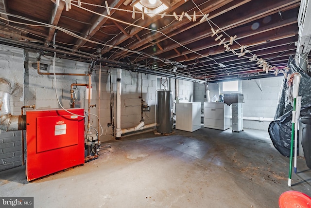 basement with water heater and washer and dryer