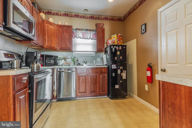 kitchen with backsplash and black appliances