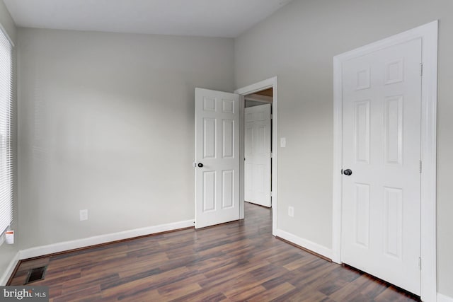 unfurnished bedroom with dark hardwood / wood-style floors