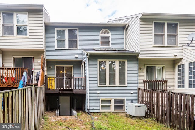 rear view of house featuring central AC