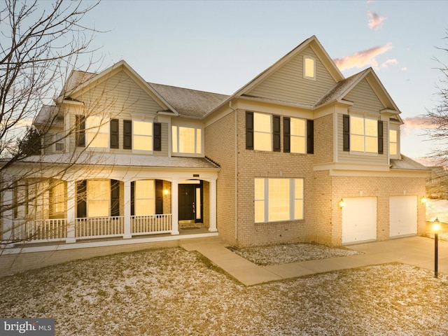 view of front of property featuring a porch and a garage