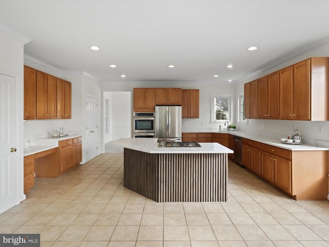 kitchen with sink, stainless steel appliances, crown molding, and a center island