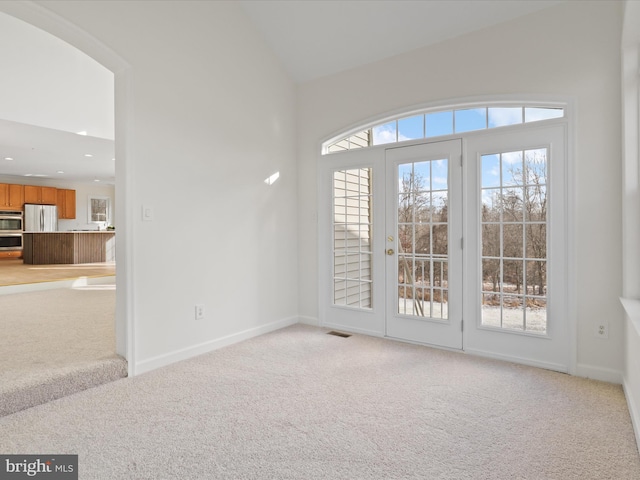 interior space with french doors and vaulted ceiling