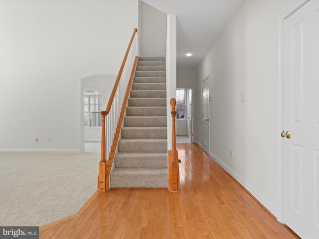 stairs with hardwood / wood-style flooring