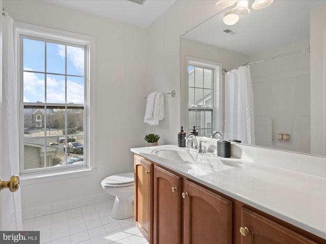 bathroom with toilet, tile patterned flooring, and vanity