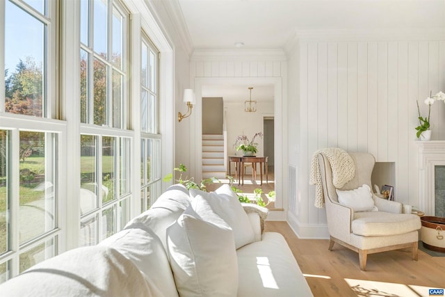 sunroom / solarium featuring an inviting chandelier