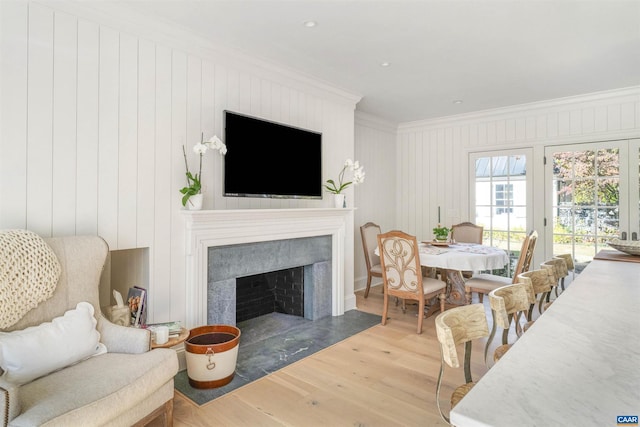 living room with wood-type flooring and ornamental molding