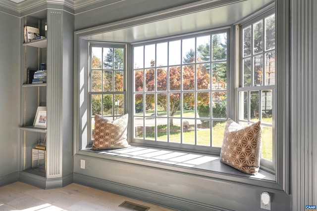 doorway featuring a wealth of natural light, crown molding, and light hardwood / wood-style floors