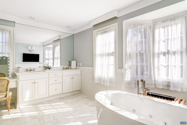 bathroom with a tub, vanity, and crown molding