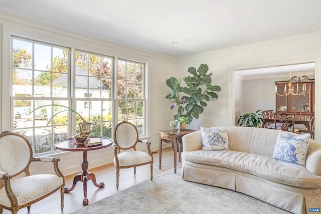 sitting room featuring crown molding, an inviting chandelier, and hardwood / wood-style flooring