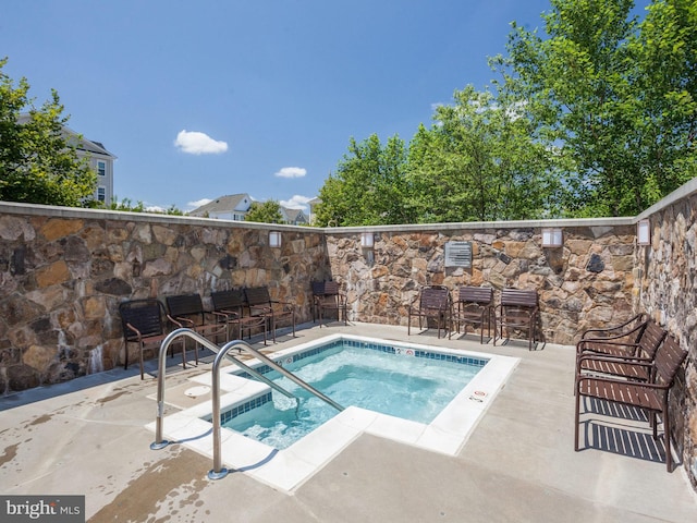 view of swimming pool featuring a community hot tub and a patio area