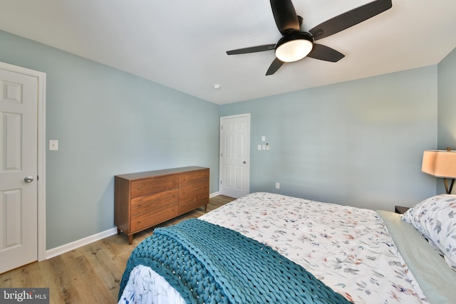 bedroom with ceiling fan and light hardwood / wood-style flooring