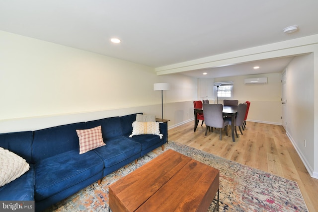 living room with light hardwood / wood-style floors and a wall mounted AC