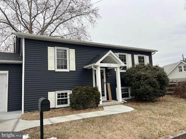 view of front facade with a front yard and a garage