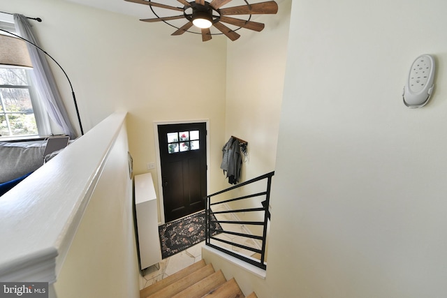 entrance foyer with light tile patterned floors and ceiling fan